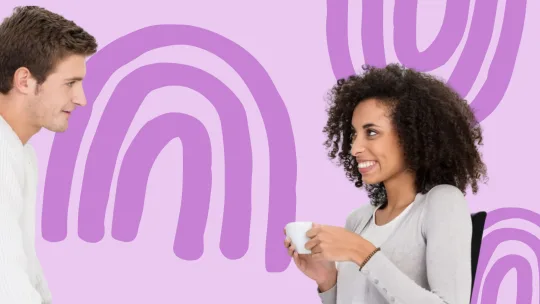 male and female coworkers smiling at each other in the office