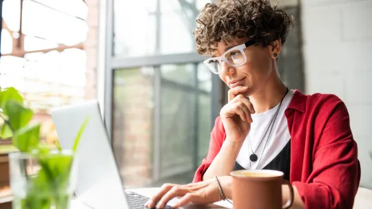 A woman types at a computer