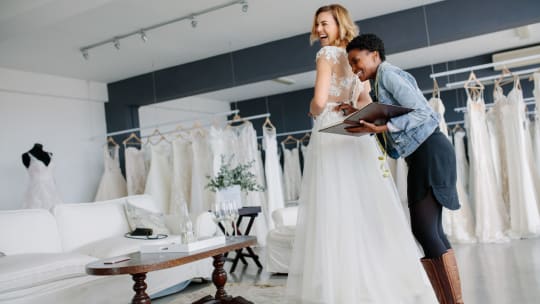 Woman trying on wedding gown