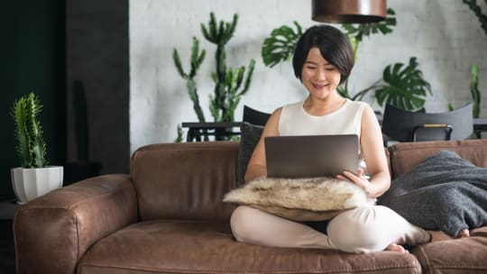 Woman using laptop at home