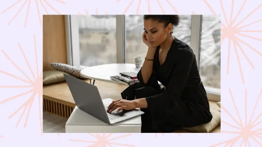 a woman sitting on her computer