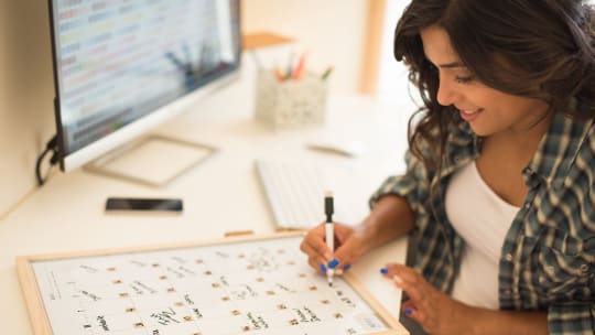 woman writing on calendar
