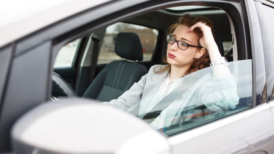 Woman Sitting in Car in Traffic