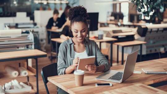 Woman sitting at table with laptop