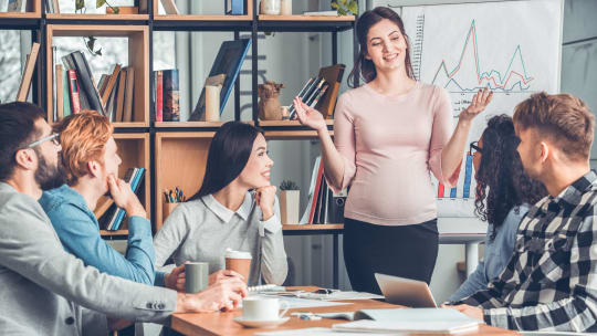 Pregnant woman leading meeting