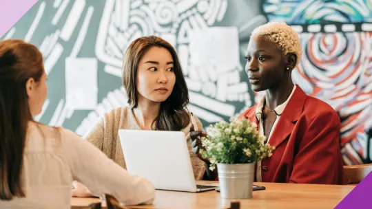 Coworkers in an office setting, illustrating the signs of a jealous coworker