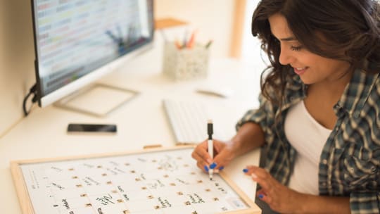 woman writing out work schedule