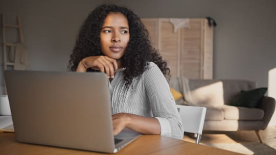 Woman thinking at desk