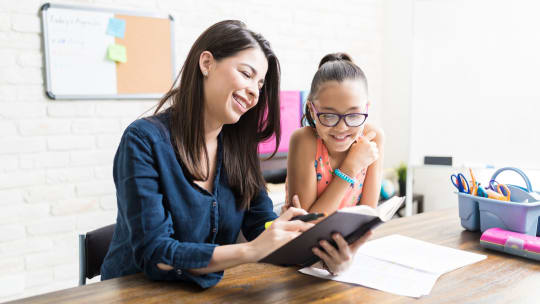 woman homeschooling her daughter