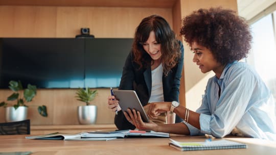 Woman receiving advice from her boss