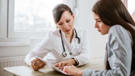 woman talking to doctor