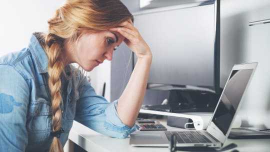 woman with job search depression looking at laptop