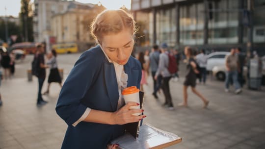 a woman has a walking meeting with a direct report