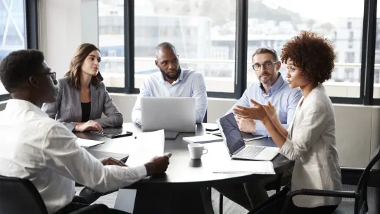 young group of colleagues in an office meeting