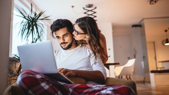 Man and woman looking at laptop