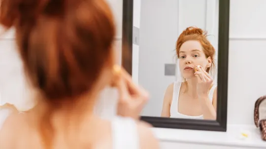 Woman looking in mirror