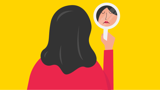 Woman looking in mirror