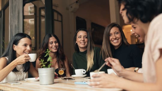 A large group of people meet in an office