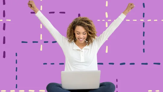 a woman in a white long sleeved shirt and blue jeans with her arms up in celebration