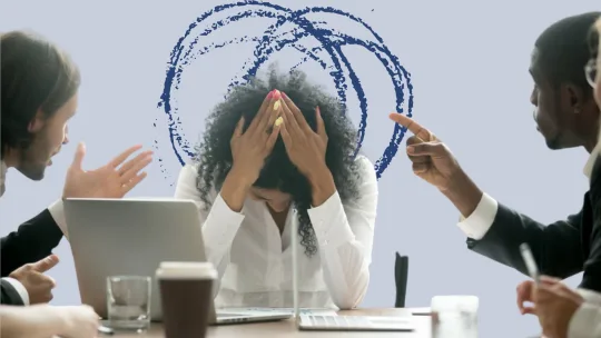 colleagues berating worker in a meeting