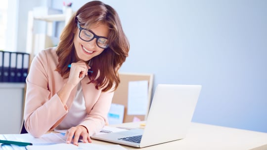 woman smiling taking notes