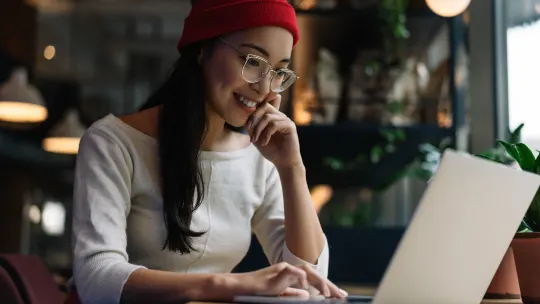 woman working on laptop smiling
