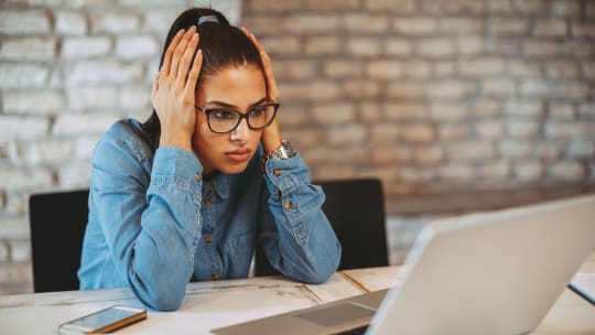 Woman staring at laptop