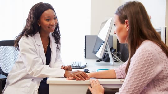 Doctor talking to woman