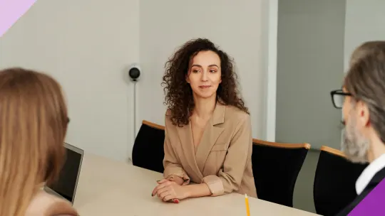 A woman having a meeting with two people asking for a job title change