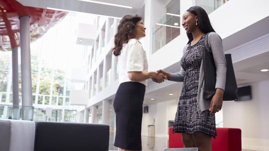 businesswomen shaking hands