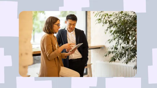 a woman and man talking in the office