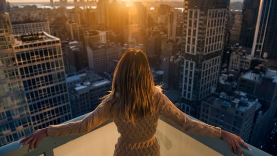 woman looking over balcony