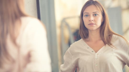 Woman Looking in Mirror
