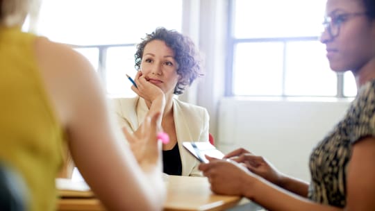 women thinking about negotiating raise