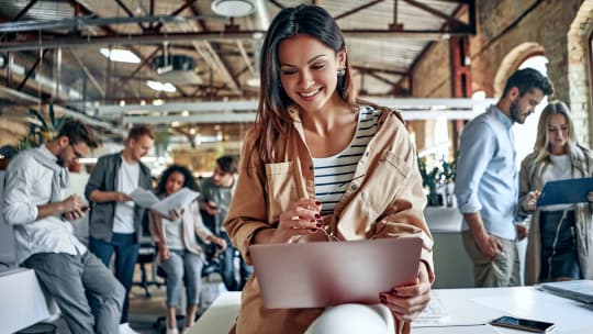 Woman sitting at table using laptop