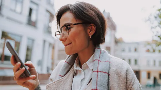 woman smiling at phone