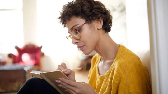 Woman writing in journal