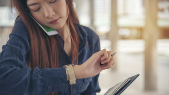woman checking watch and appointment