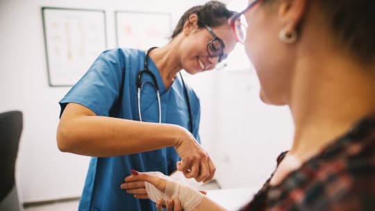 Nurse assists woman 