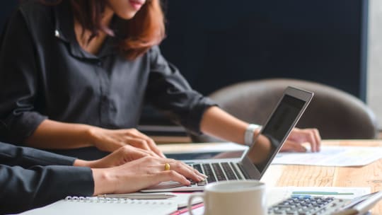 women calculating earnings