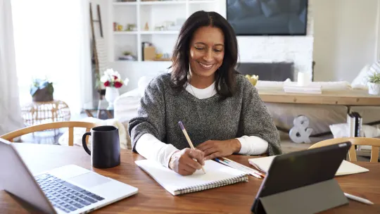 Happy woman writing