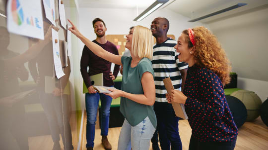 happy woman participating in activity with coworkers