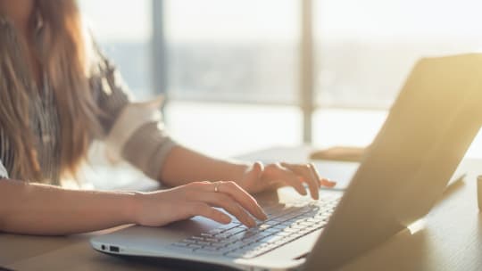 woman typing on computer