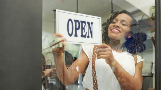 small business owner posting open sign