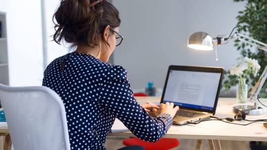 woman typing on her laptop