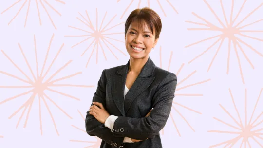 a woman smiling and crossing her arms