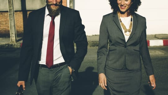 Business woman and man, walking together