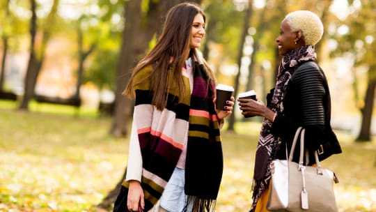Two women meeting in a park
