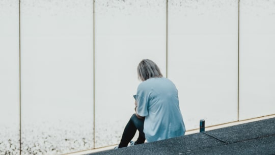 Woman sitting alone on steps