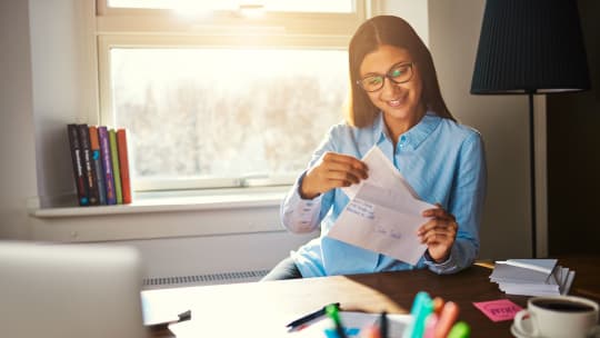 Happy woman with paycheck 
